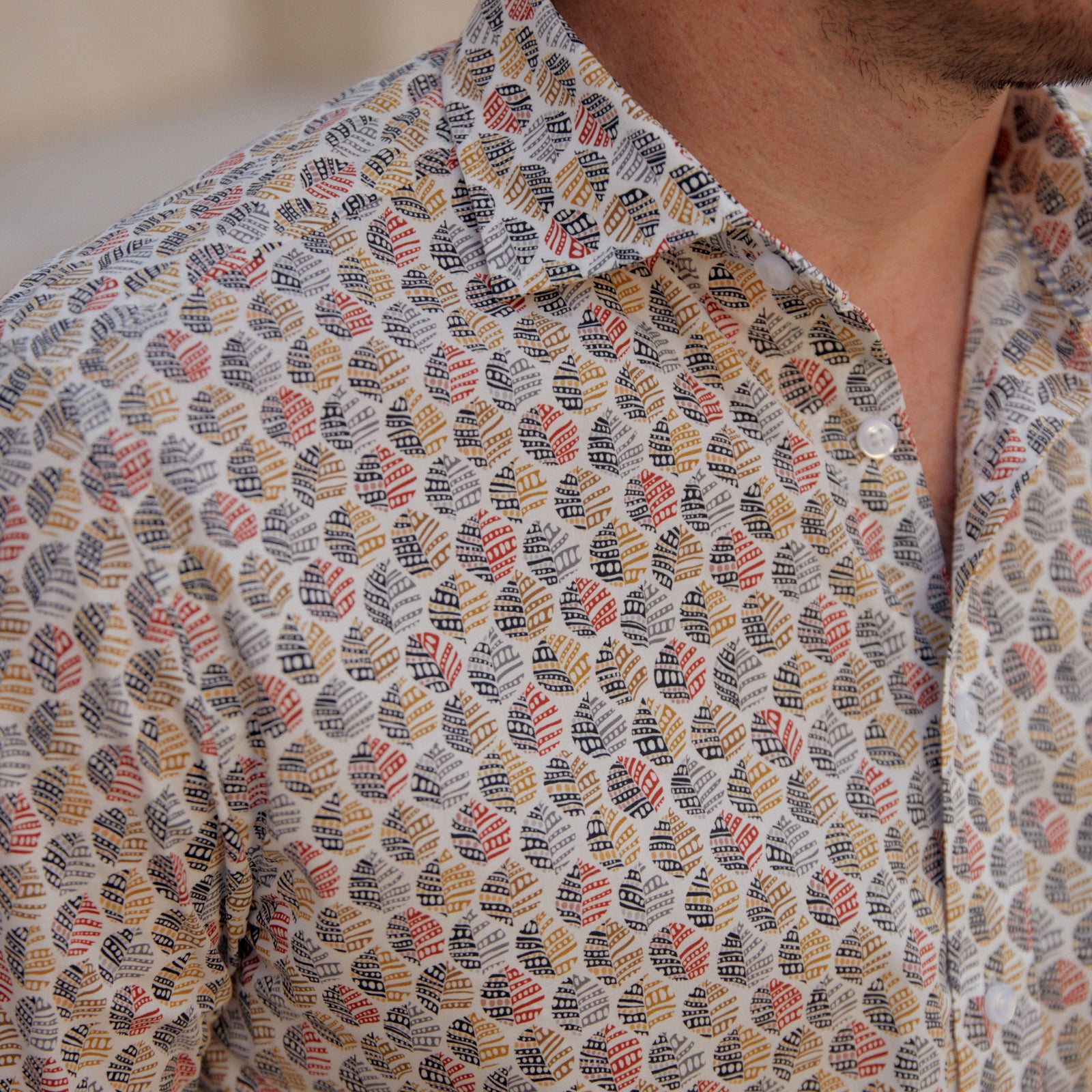 The Carroll Red & BlackPrint Shirt features a daring leaf pattern in vivid reds, blacks, and tans. Featuring striking white buttons, this sport shirt will take you from the office to the outdoors with a fearless look.  100% Cotton • Spread Collar • Long Sleeve • Machine Washable • Made in Italy • Return Policy