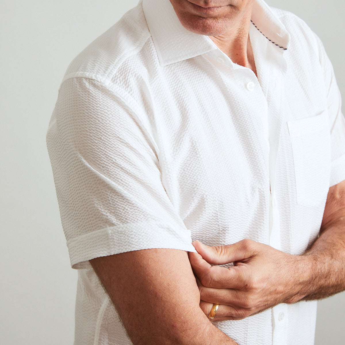 A solid look for a solid guy. THE white shirt you need this season. Seersucker, lightweight, and supremely cool. Available in short or long sleeve.  100% Cotton Seersucker  •  Spread Collar  •  Short Sleeve  •  Contrast Buttons  •  Chest Pocket  •  Machine Washable  •  Made in Italy