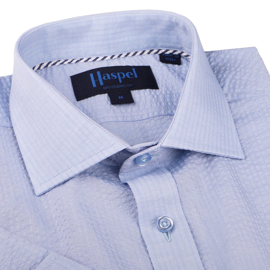 A solid look for a solid guy. The most beautiful light blue long sleeve shirt soon to be on your statuesque frame. Seersucker, lightweight, and supremely cool.  100% Cotton Seersucker  •  Spread Collar  •  Long Sleeve  •  Chest Pocket  •  Machine Washable  •  Made in Italy