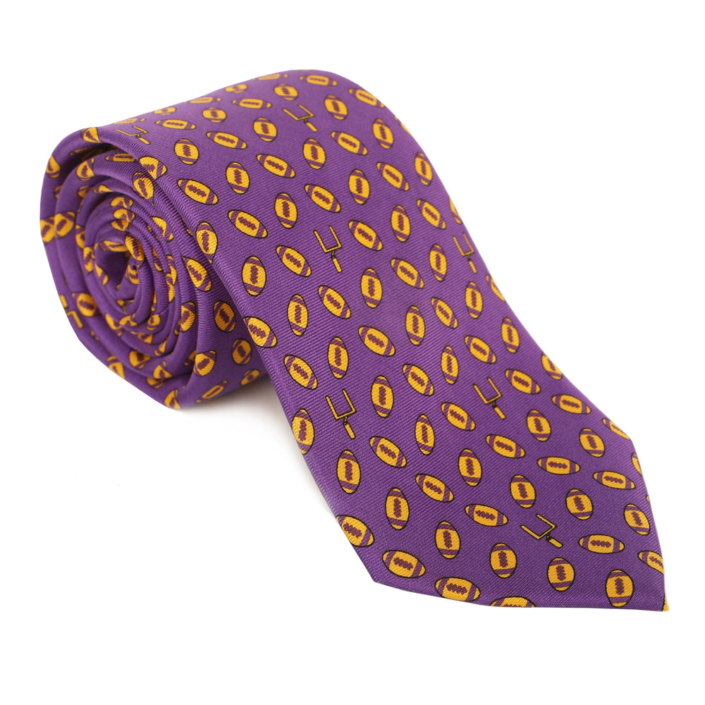 Represent like royalty in our regal 100% silk ties. Purple & gold and good to geaux (go)! Tie one on so you can tie one on! Limited Edition Haspel x NOLA Couture Exclusive Collaboration • 100% Silk • 3" Wide • Seersucker Tipped and Seersucker Keeper • Made in USA