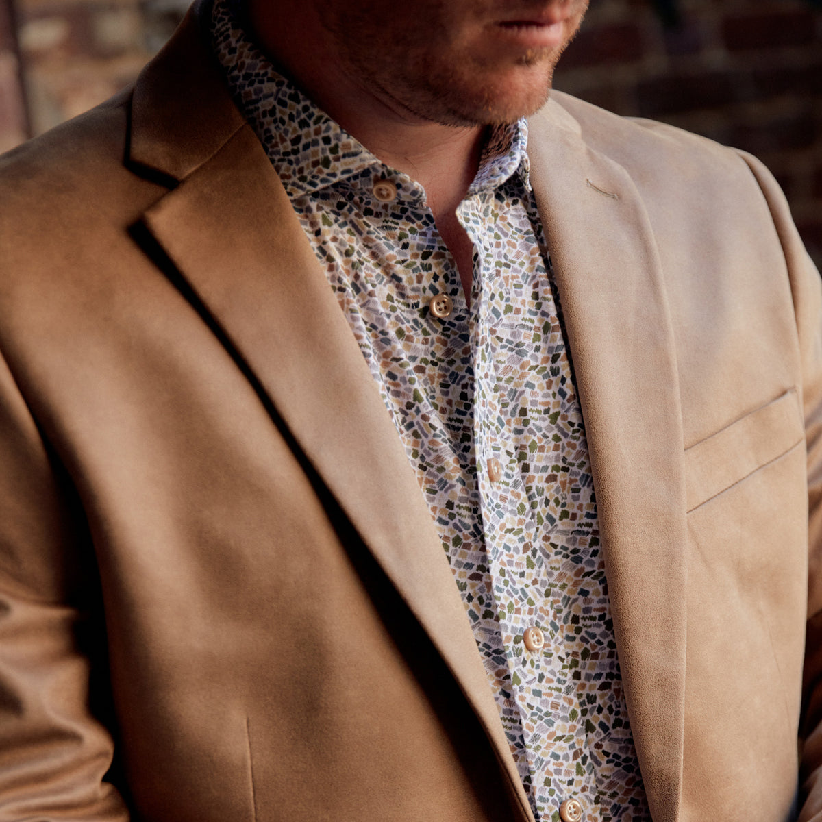 This striking Carroll Olive &amp; Tan Print adds a sophisticated touch to any wardrobe. The olive and tan mosaic print is offset with tan buttons to create an eye-catching look, perfect for a night in New Orleans or wherever your good times take you!  100% Cotton • Spread Collar • Long Sleeve • Machine Washable • Made in Italy • Return Policy