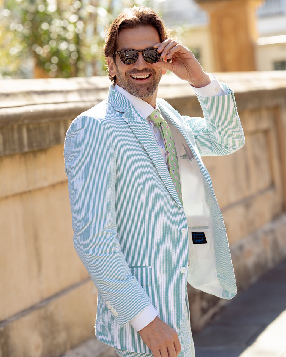 The chill of a pewter cup, the finish of a fine Kentucky bourbon, & the crunch of that good ice - get that Derby Day feeling in our refreshingly minty stretch seersucker.   97% Cotton / 3% Lycra Haspel Exclusive Seersucker Stretch Fabric • Maximized Seersucker Pucker • Audubon Classic Fit • Natural Shoulder • Two Buttons • Flap Pockets • 3/4 Lined for Maximum Cool • Side Vents • Notch Lapel • Dry Clean • Made in USA