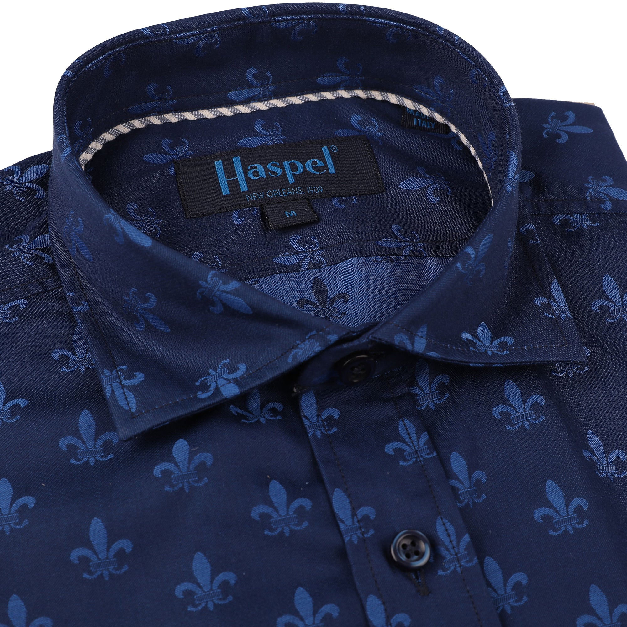 Let your New Orleans style shine with this Carroll Royal Blue Fleur De Lis Sport Shirt. Featuring a subtle fleur de lis pattern and navy-blue buttons, this sporty, yet stylish, shirt will be the talk of the town! Show off your chic Louisiana flair in this royal blue beauty fit for a King.  100% Cotton • Spread Collar • Long Sleeve • Machine Washable • Made in Italy • Return Policy