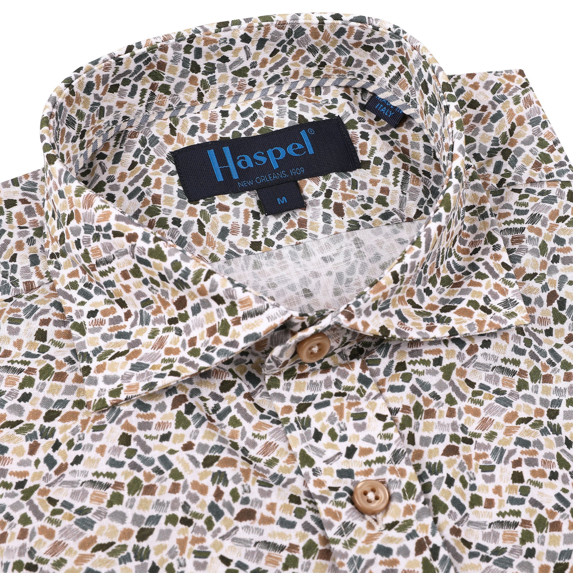 This striking Carroll Olive & Tan Print adds a sophisticated touch to any wardrobe. The olive and tan mosaic print is offset with tan buttons to create an eye-catching look, perfect for a night in New Orleans or wherever your good times take you!  100% Cotton • Spread Collar • Long Sleeve • Machine Washable • Made in Italy • Return Policy