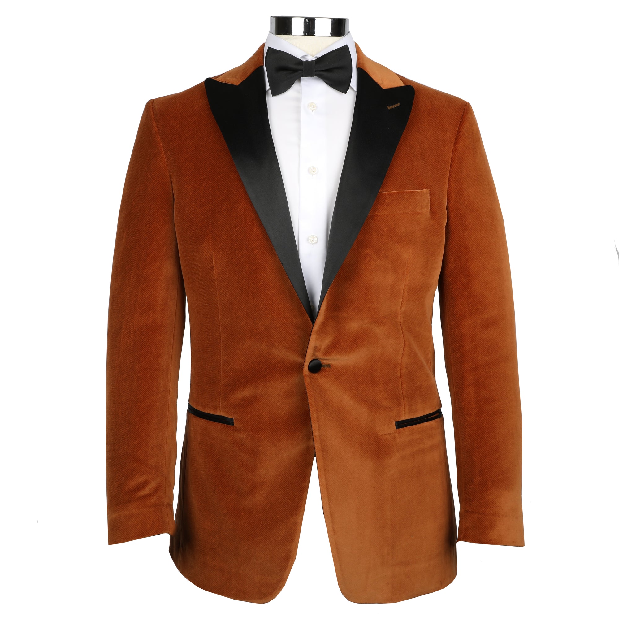Turn heads and express your style with the Toulouse Tobacco Velvet Dinner Jacket. This retro-inspired jacket is tailored from luxurious velvet, offering an elegant statement piece for any occasion. Its tobacco coloring adds a timeless appeal, perfect for a classic look that stands out.  100% Cotton • Toulouse Tailored Fit • Natural Shoulder • One Button Closure • Satin Trim Besom Pockets • Satin Covered Buttons• Fully Lined • 2 Side Vents • Satin Peak Lapel • Dry Clean Only