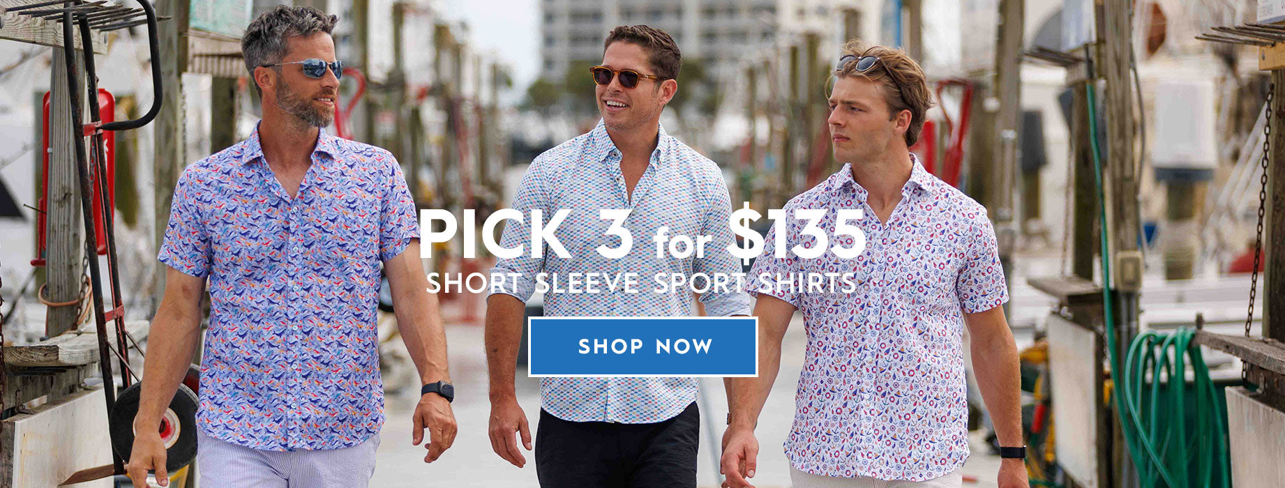 Three men walking outdoors on a dock wearing matching short-sleeve patterned sport shirts. Large overlaid text reads 'PICK 3 for $135 SHORT SLEEVE SPORT SHIRTS' with a blue 'SHOP NOW' button.