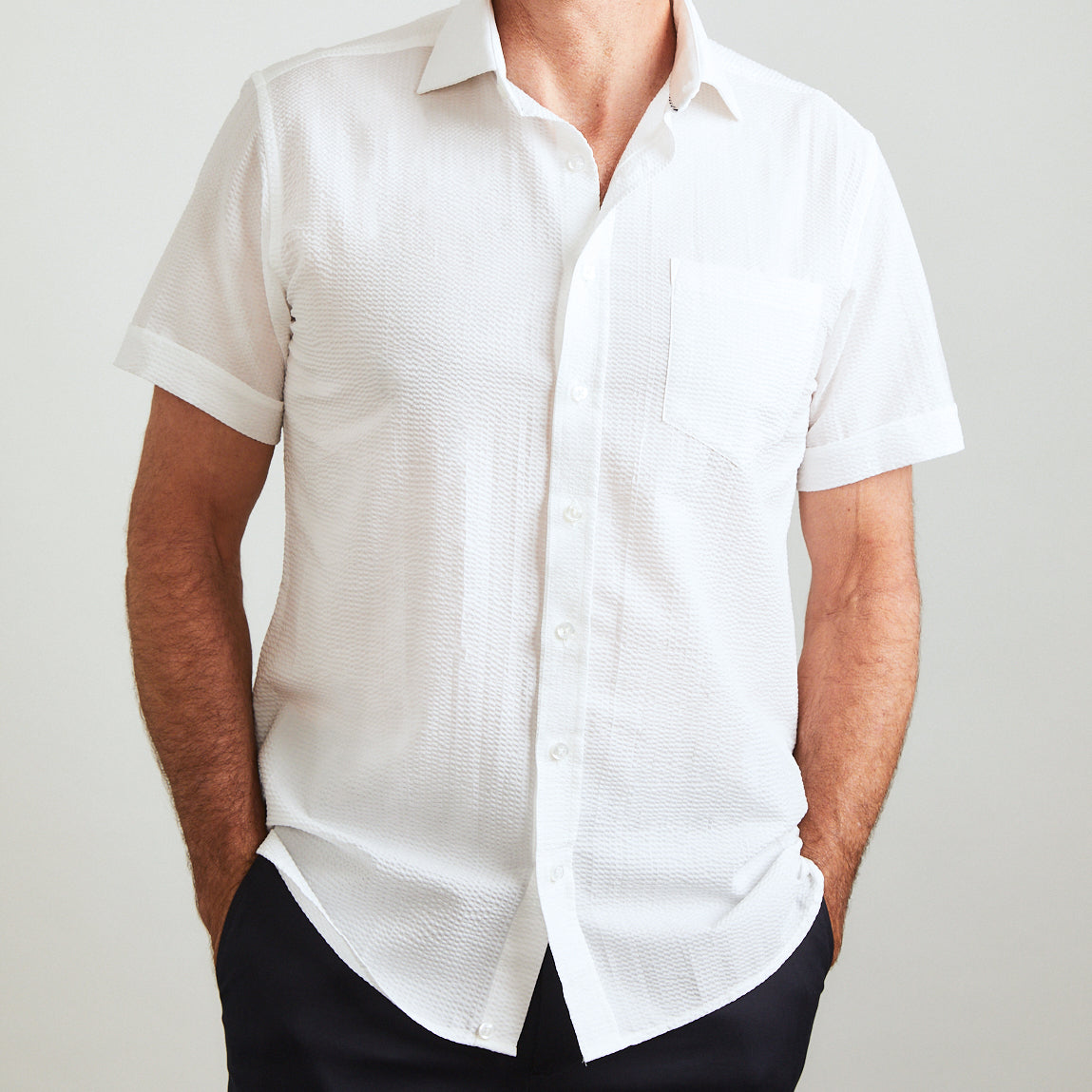 A solid look for a solid guy. THE white shirt you need this season. Seersucker, lightweight, and supremely cool. Available in short or long sleeve.  100% Cotton Seersucker  •  Spread Collar  •  Short Sleeve  •  Contrast Buttons  •  Chest Pocket  •  Machine Washable  •  Made in Italy