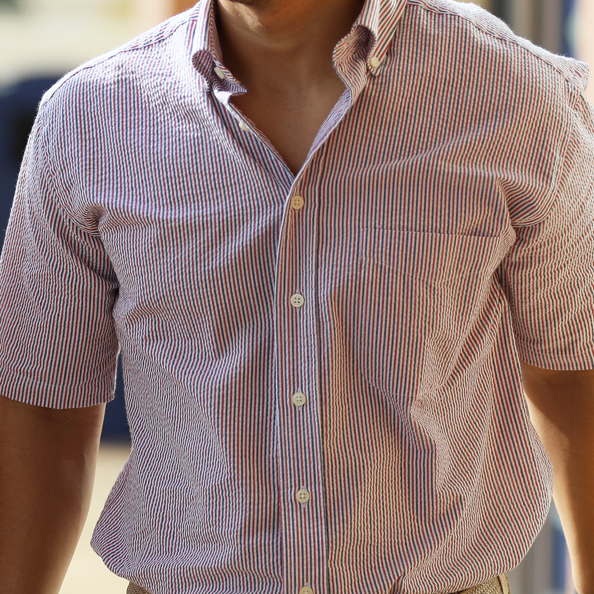 Seersucker all year long in a classic red, white, &amp; blue seersucker shirt. Subtle, lightweight, and a texture they begs a second look.  100% Cotton Seersucker • Button Down Collar • Short Sleeve • Chest Pocket • Machine Washable • Made in Italy