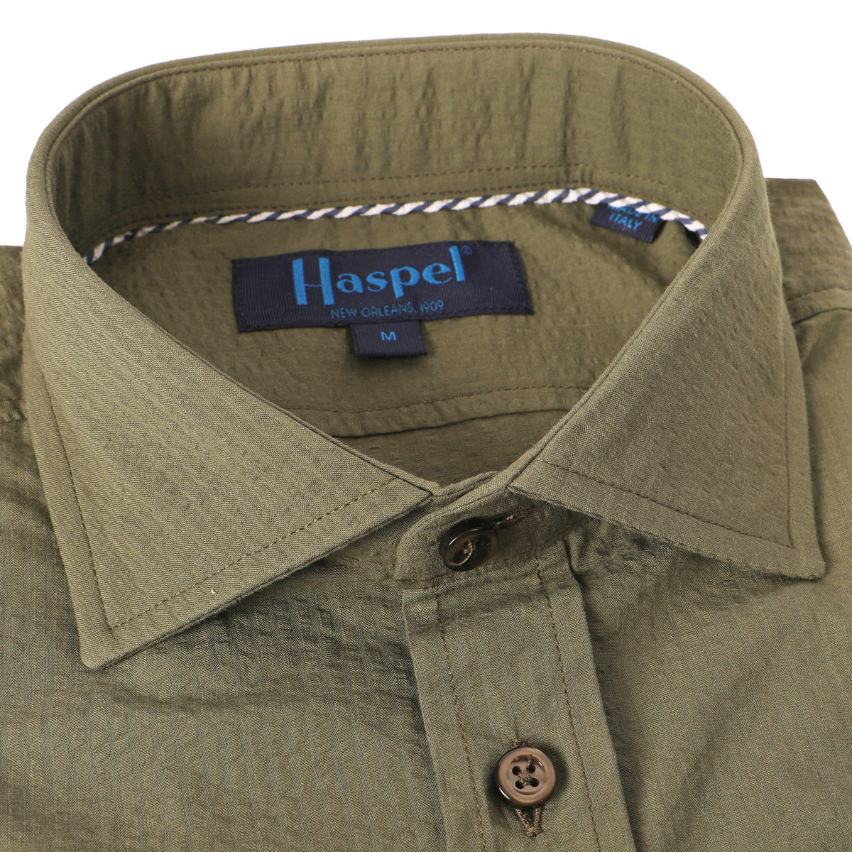 Seersucker all year long in a green olive seersucker shirt. Subtle, lightweight, and a texture they begs a second look.  100% Cotton Seersucker  •  Spread Collar  •  Long Sleeve  •  Chest Pocket  •  Machine Washable  •  Made in Italy