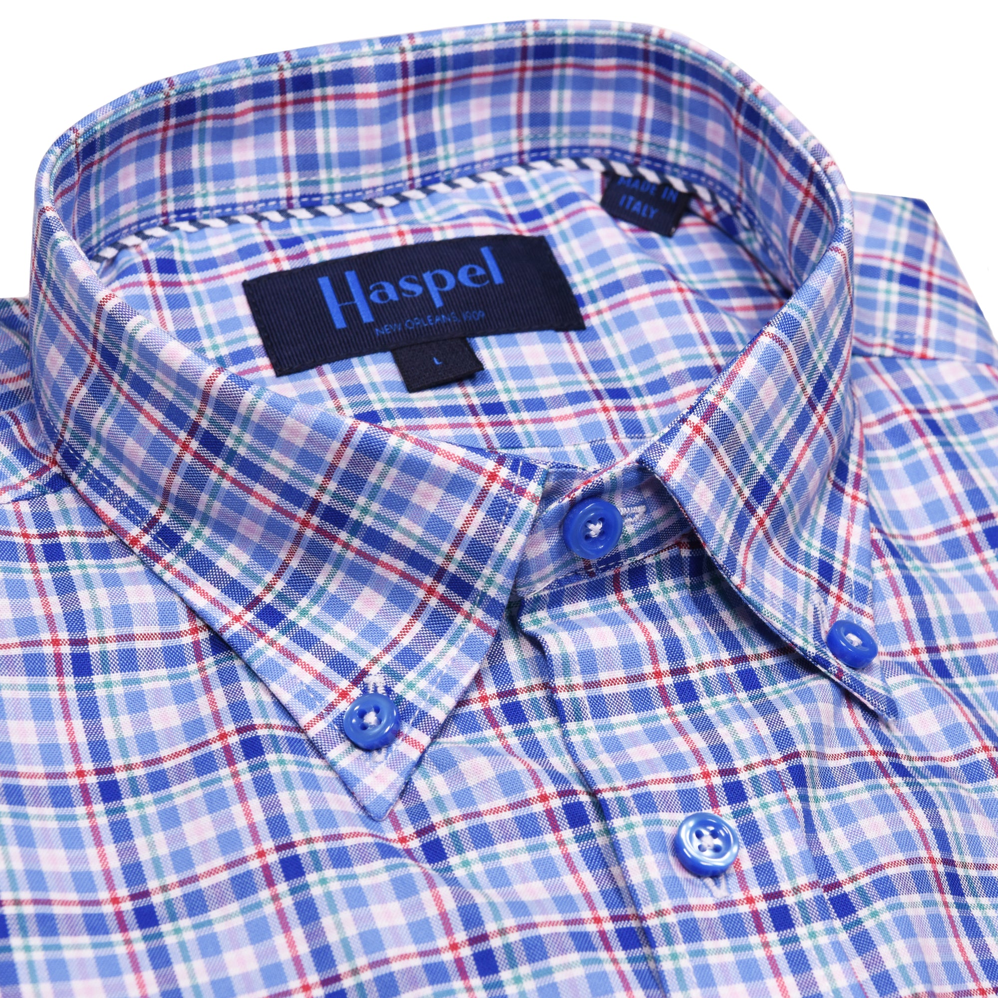 Another blue plaid shirt this is not. Stunning blue buttons highlight this complex yet simply plaid print shirt. Fine lines of red, green, and pink will make them take a closer look. Complex yet smooth, like a sip of Pappy's.  100% Cotton • Button Down Collar • Long Sleeve • Chest Pocket • Machine Washable • Made in Italy